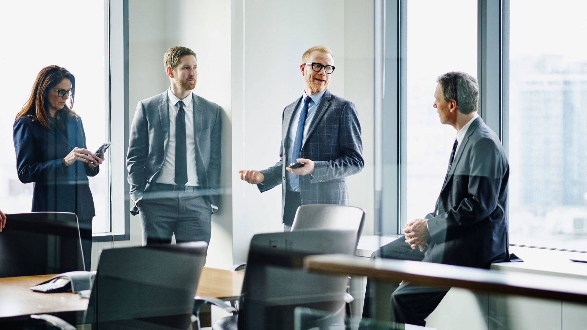 Empowering Decisions with Mergers and Acquisitions Insurance | Group in a conference room, discussing secure deals and risk management.